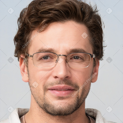 Joyful white adult male with short  brown hair and grey eyes