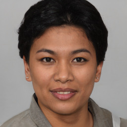 Joyful asian young-adult female with short  black hair and brown eyes