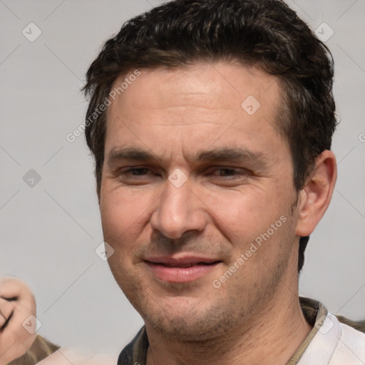 Joyful white adult male with short  brown hair and brown eyes