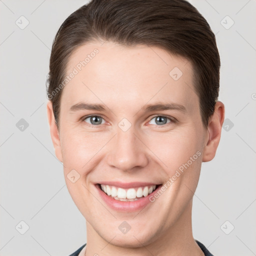 Joyful white young-adult male with short  brown hair and grey eyes