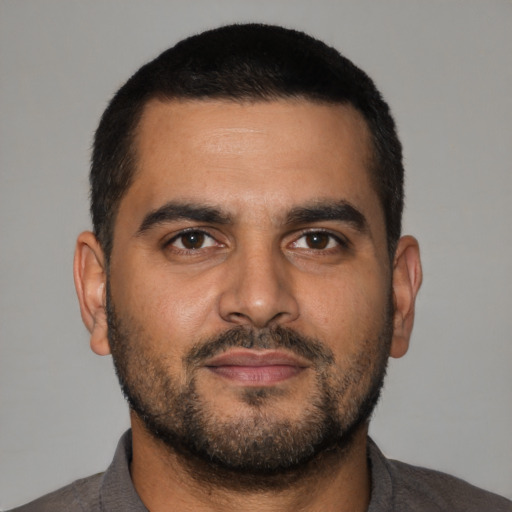 Neutral latino young-adult male with short  black hair and brown eyes
