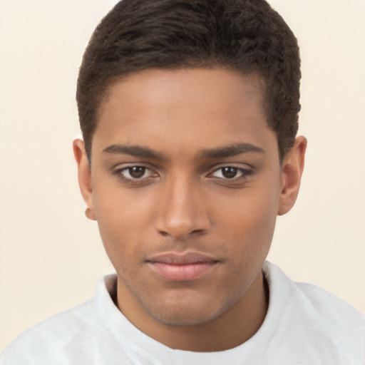 Joyful black young-adult male with short  brown hair and brown eyes