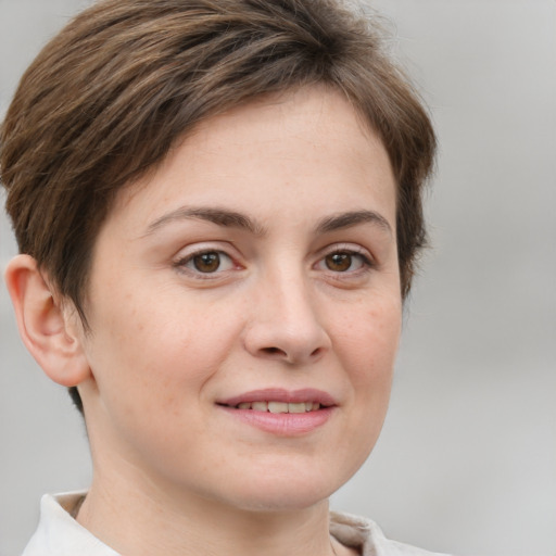 Joyful white young-adult female with short  brown hair and grey eyes