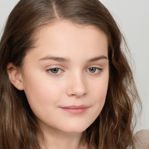 Joyful white child female with long  brown hair and brown eyes