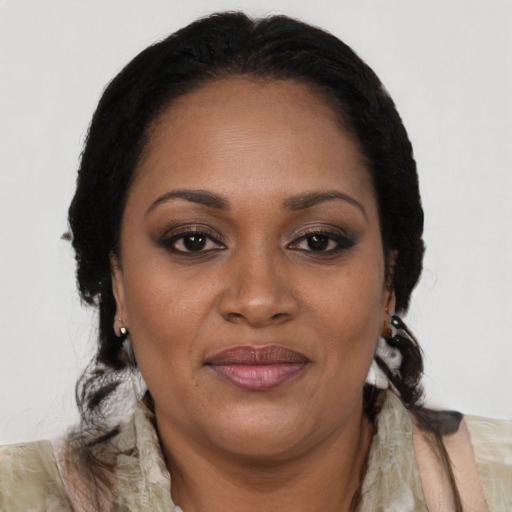 Joyful black adult female with long  brown hair and brown eyes