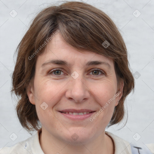 Joyful white adult female with medium  brown hair and grey eyes