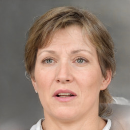 Joyful white adult female with medium  brown hair and grey eyes