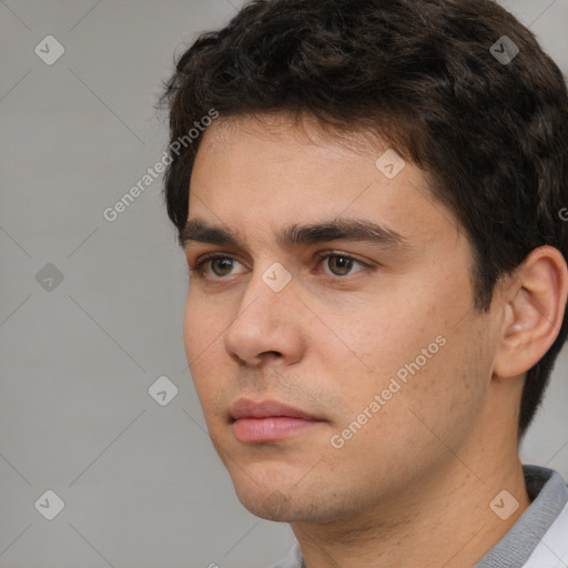 Neutral white young-adult male with short  black hair and brown eyes