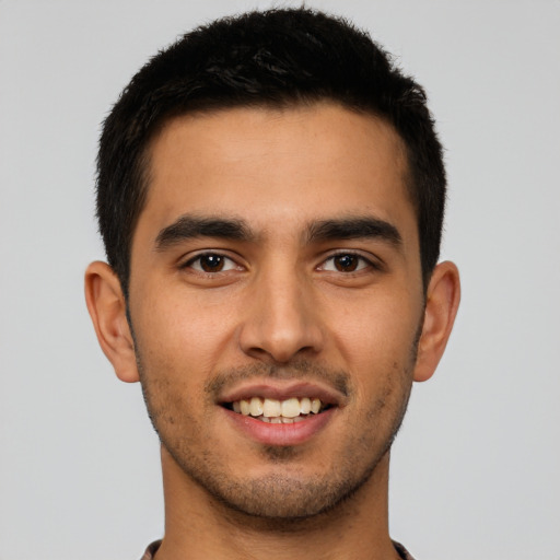 Joyful latino young-adult male with short  brown hair and brown eyes