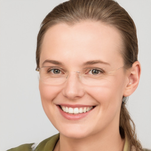 Joyful white young-adult female with long  brown hair and grey eyes