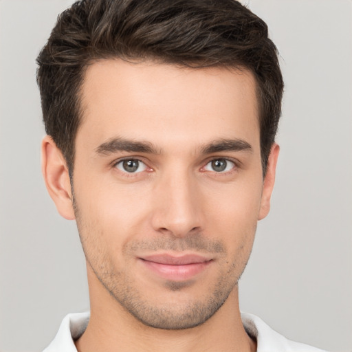 Joyful white young-adult male with short  brown hair and brown eyes