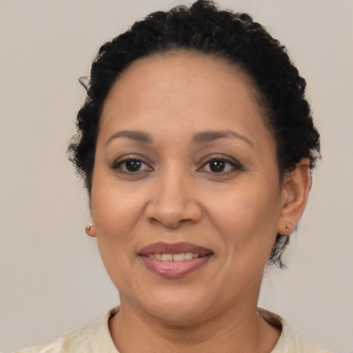 Joyful latino adult female with short  brown hair and brown eyes