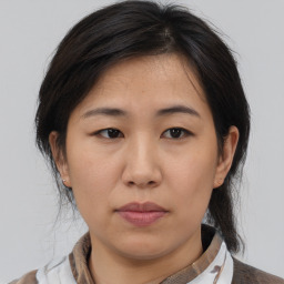 Neutral asian young-adult female with medium  brown hair and brown eyes