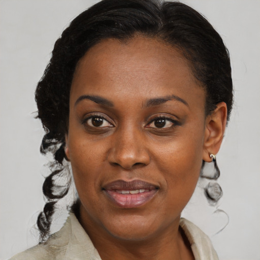 Joyful black adult female with medium  brown hair and brown eyes