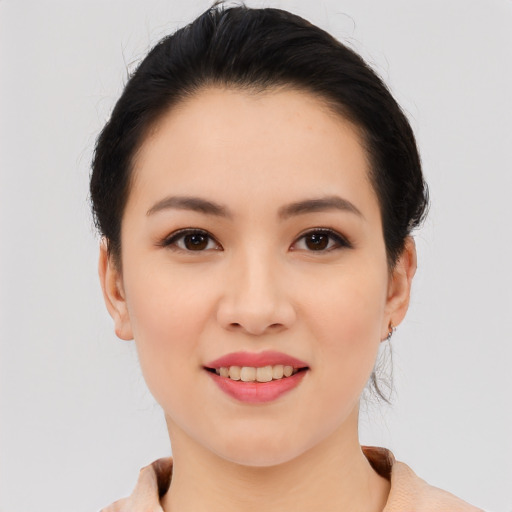 Joyful asian young-adult female with short  black hair and brown eyes