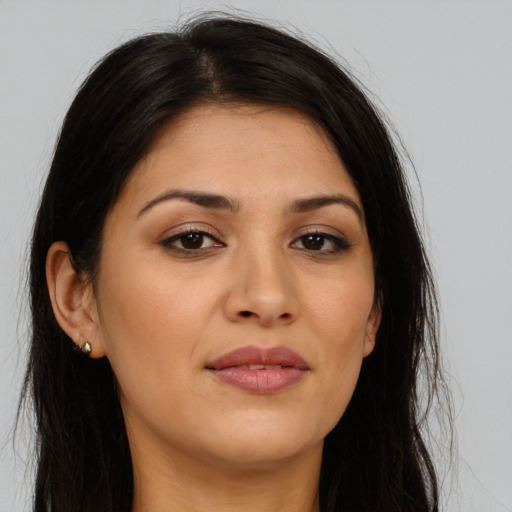 Joyful latino young-adult female with long  brown hair and brown eyes