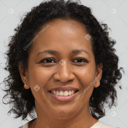 Joyful black adult female with medium  brown hair and brown eyes