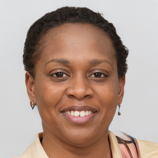 Joyful black adult female with short  brown hair and brown eyes