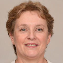 Joyful white middle-aged female with medium  brown hair and blue eyes