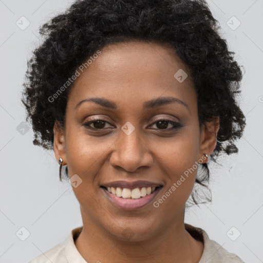 Joyful black young-adult female with short  brown hair and brown eyes