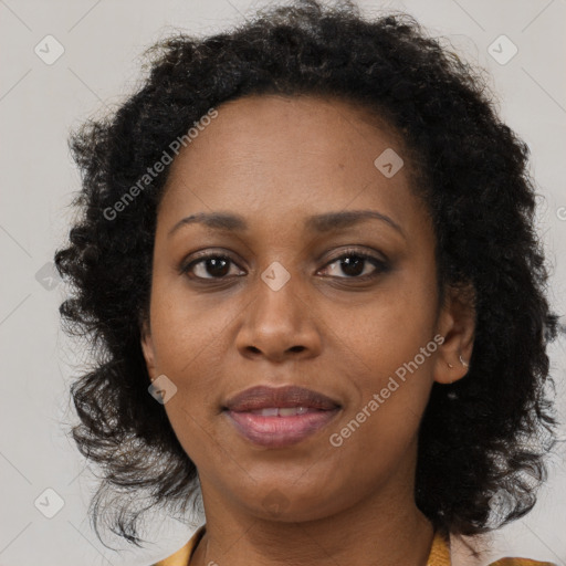 Joyful black adult female with medium  brown hair and brown eyes