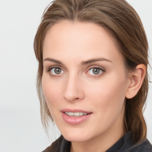 Joyful white young-adult female with long  brown hair and blue eyes