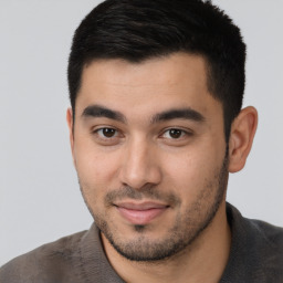 Joyful latino young-adult male with short  brown hair and brown eyes