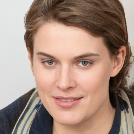 Joyful white young-adult female with medium  brown hair and blue eyes