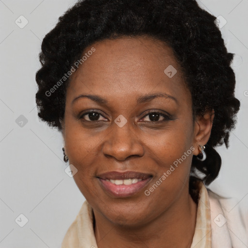 Joyful black adult female with long  brown hair and brown eyes
