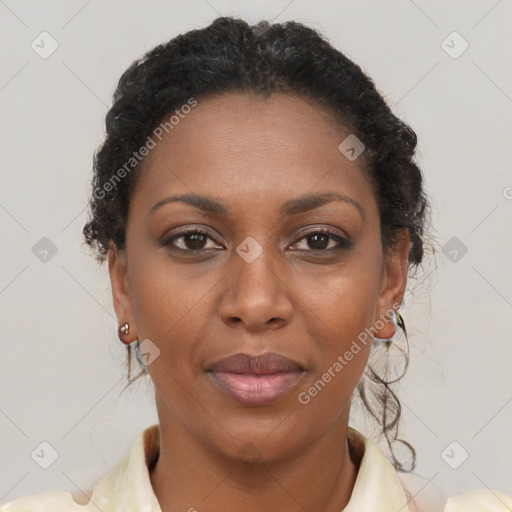 Joyful black young-adult female with long  brown hair and brown eyes