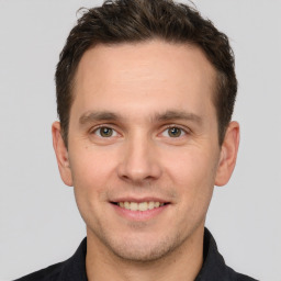 Joyful white young-adult male with short  brown hair and brown eyes