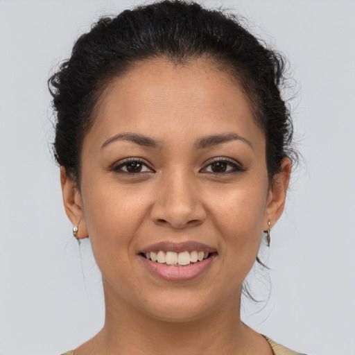 Joyful latino young-adult female with short  brown hair and brown eyes