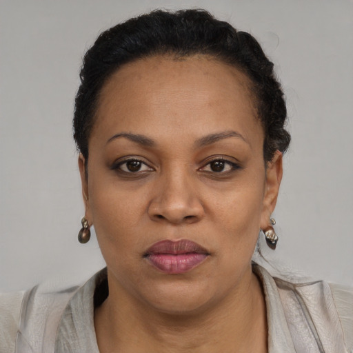 Joyful black adult female with short  brown hair and brown eyes