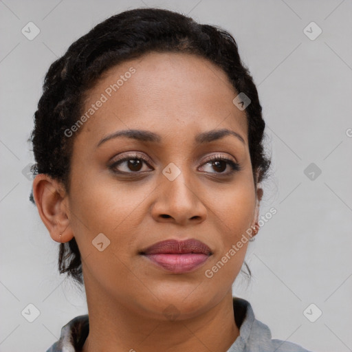 Joyful black young-adult female with long  brown hair and brown eyes