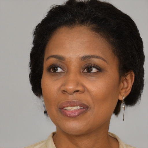 Joyful black adult female with short  brown hair and brown eyes