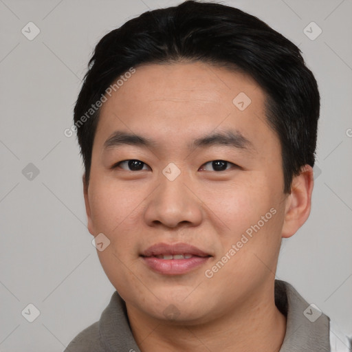 Joyful asian young-adult male with short  black hair and brown eyes