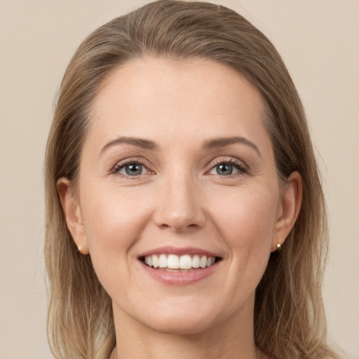 Joyful white young-adult female with long  brown hair and grey eyes