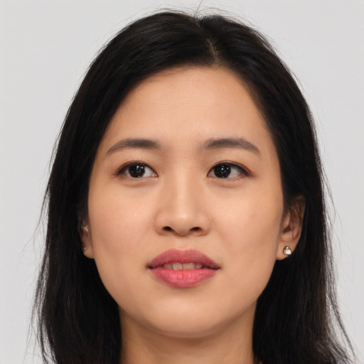 Joyful asian young-adult female with long  black hair and brown eyes