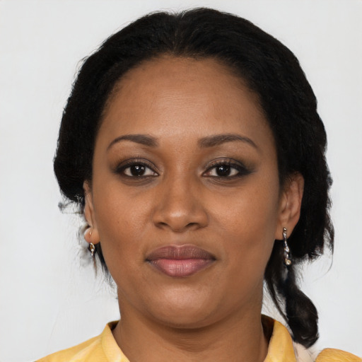 Joyful black adult female with long  black hair and brown eyes
