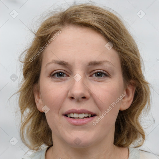 Joyful white young-adult female with medium  brown hair and blue eyes