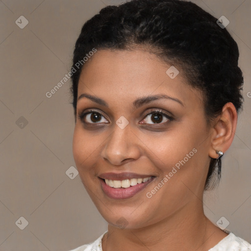 Joyful black young-adult female with short  brown hair and brown eyes