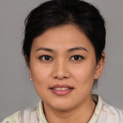Joyful asian young-adult female with medium  brown hair and brown eyes