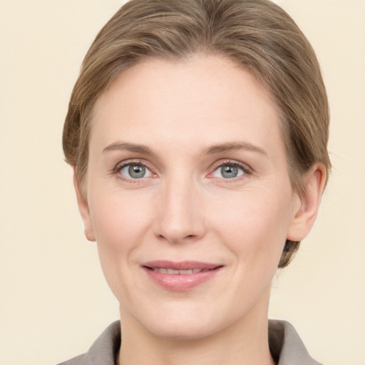 Joyful white adult female with medium  brown hair and grey eyes