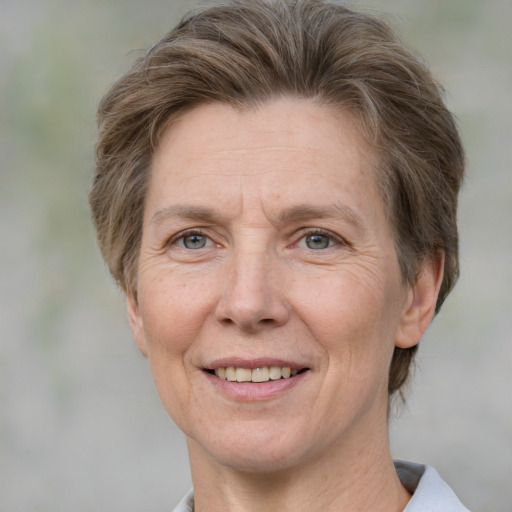 Joyful white adult female with short  brown hair and grey eyes