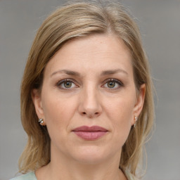 Joyful white adult female with medium  brown hair and grey eyes