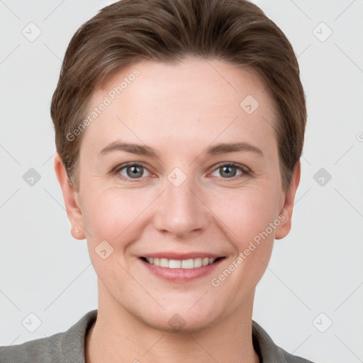 Joyful white young-adult female with short  brown hair and grey eyes