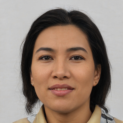 Joyful asian young-adult female with medium  brown hair and brown eyes