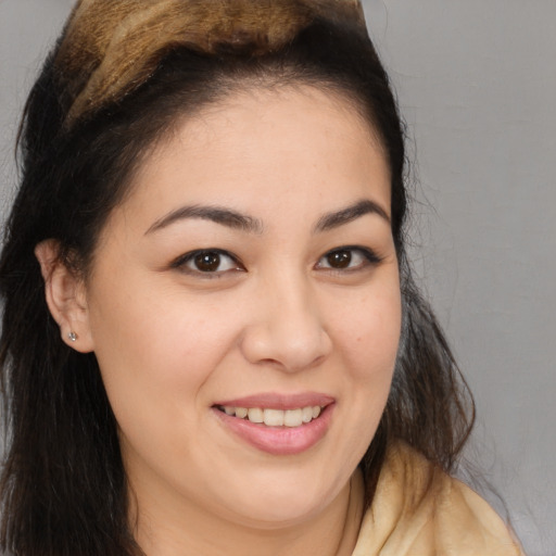 Joyful white young-adult female with long  brown hair and brown eyes
