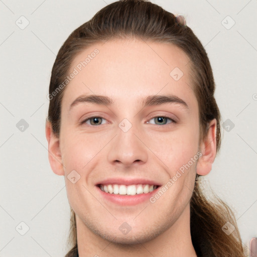 Joyful white young-adult female with long  brown hair and grey eyes