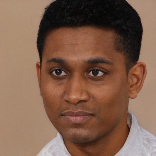 Joyful black young-adult male with short  black hair and brown eyes
